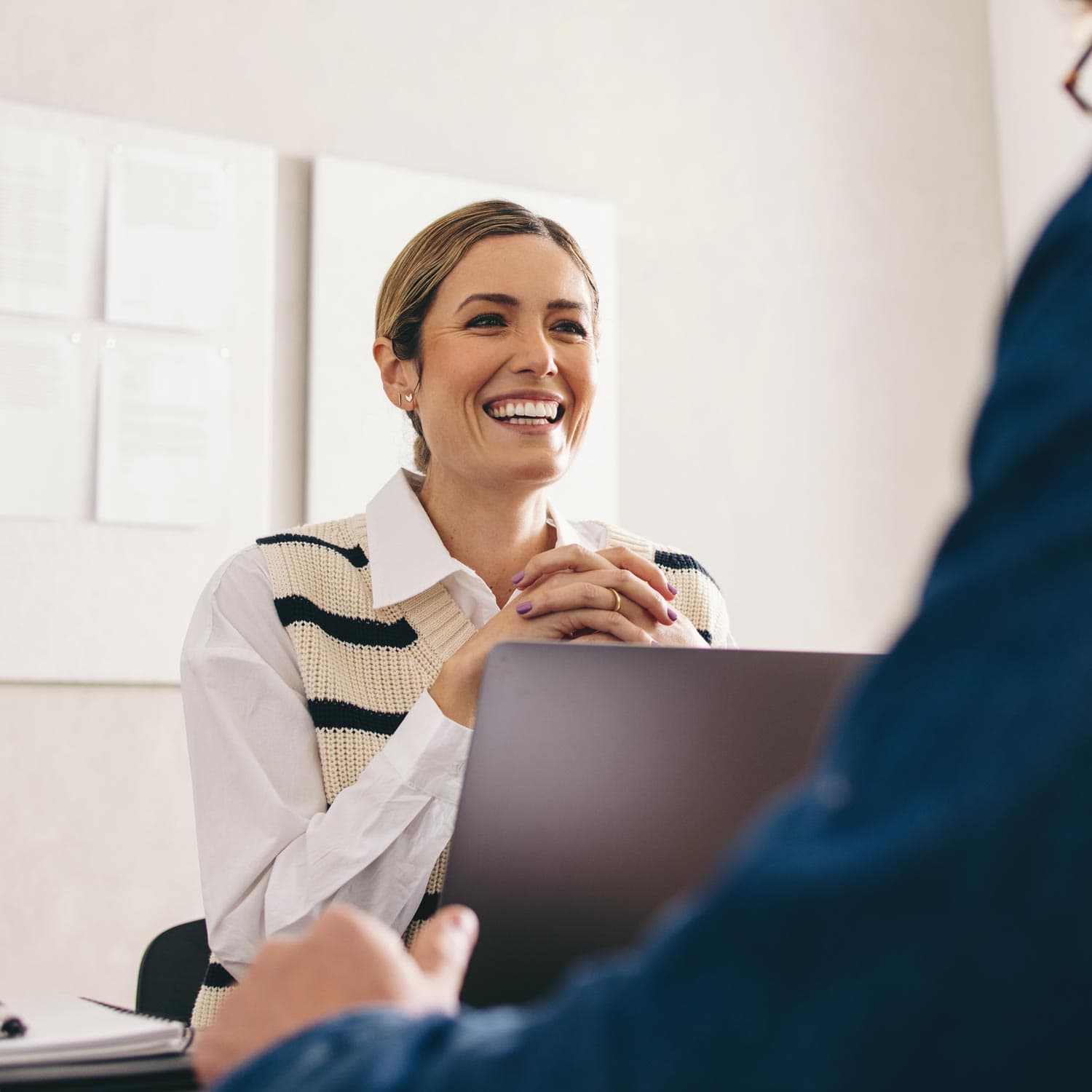 Photo of smiling woman working on laptop